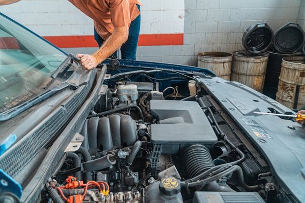 What are the steps for testing and maintaining a vehicle's oil pressure sensor?